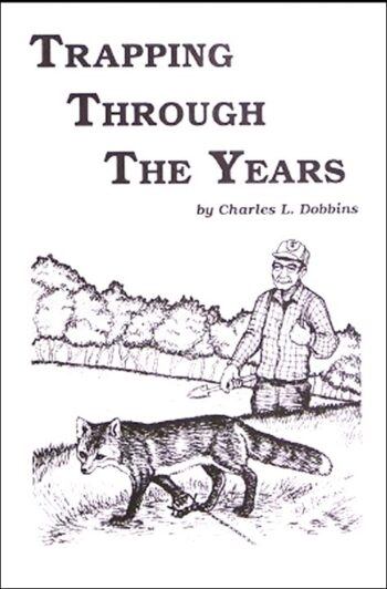 Cover of "Trapping Through the Years" by Charles L. Dobbins, featuring an illustration of a trapper and a fox in the woods.