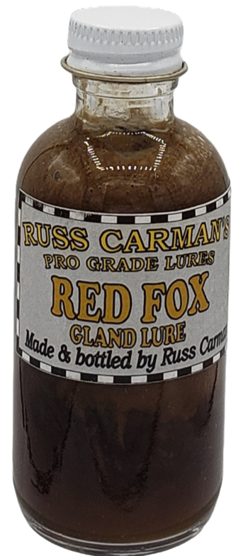 Small glass bottle of Carman's Pro Grade Red Fox Gland Lure with a black and white checked label.