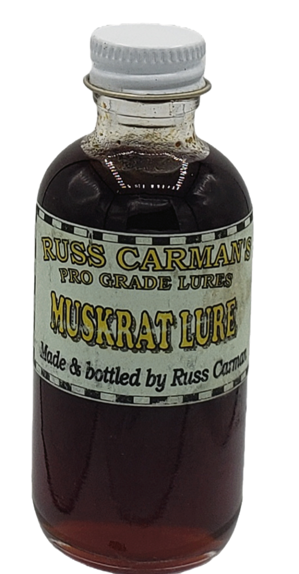 Carman's Pro Grade Muskrat Lure comes in a bottle with dark liquid and a white cap.