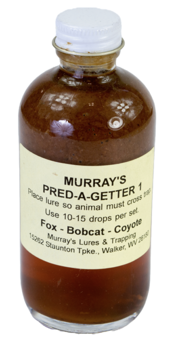 A brown glass bottle labeled "Murray's Pred-A-Getter #1 Lure" with instructions for trapping foxes and bobcats.