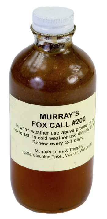 A bottle of "Murray's Fox Call #200 Lure" holds brown trapping liquid, includes usage instructions, and contact details.