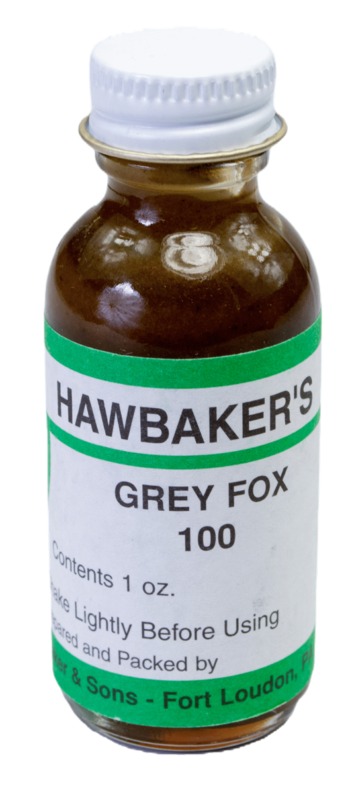 A small "Hawbaker's Grey Fox 100 Lure" with a white lid, renowned for trapping, marked to shake before use.