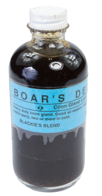 The "Blackie's Boar's Delight Lure" glass bottle contains a dark liquid, a top trapping product by Blackie's Blend.