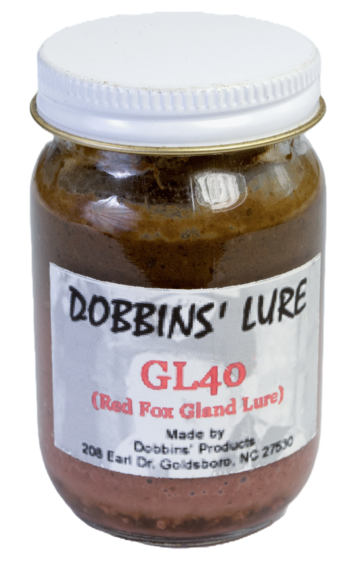 Jar labeled "Dobbins' G.L. 40 Lure," with red fox gland essence from Goldsboro, NC. Contains brown substance.