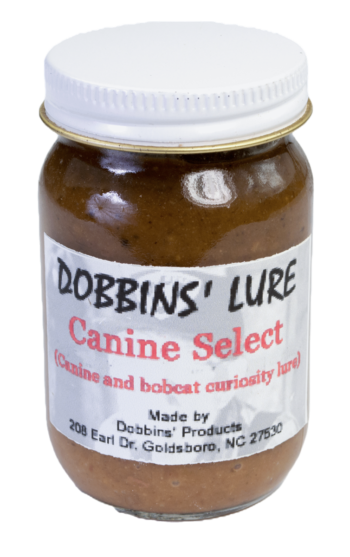 Jar labeled "Dobbins' Canine Select Lure," a top bobcat and coyote lure by Dobbins' Products, Goldsboro, NC.