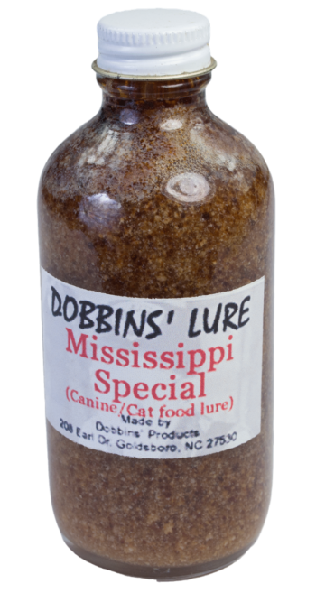 A bottle of Dobbins' Mississippi Special Lure, designed as an effective canine trapping lure.