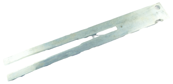 The Mityling Trap Bedder is a flat, elongated metal tool with two prongs and a hole at one end.